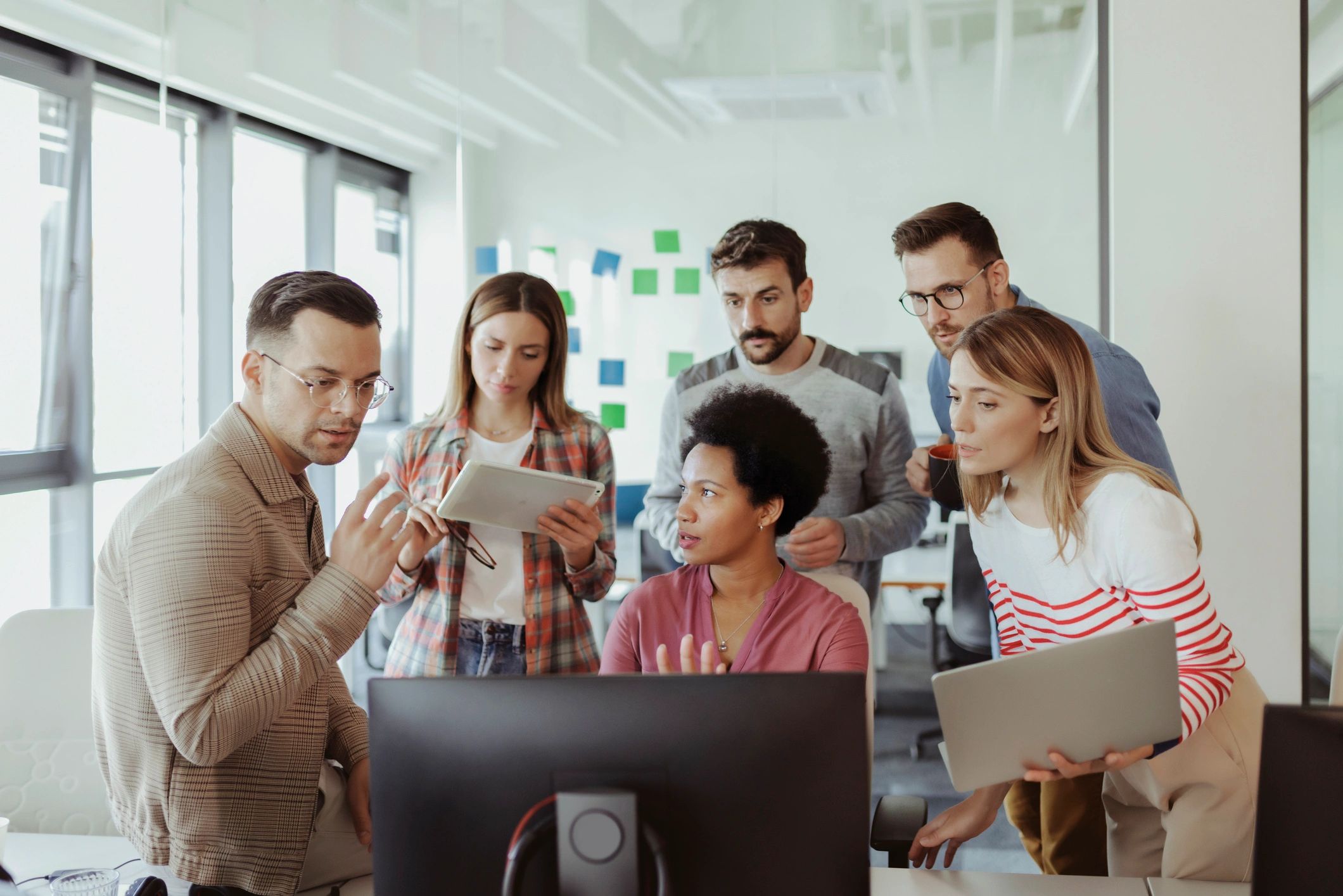 Software development team collaborating in a bright office