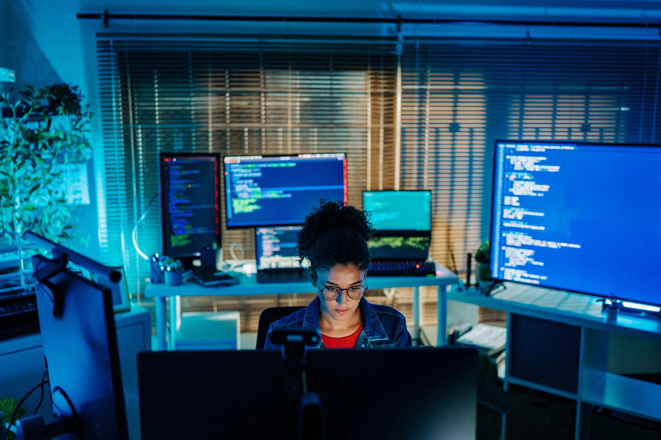 Software developer working at a multi-monitor workstation